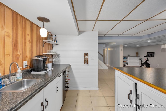 431 Homecrest Ave, Kalamazoo, MI 49001 - kitchen with dark countertops, light tile patterned flooring, white cabinetry, open shelves, and a drop ceiling