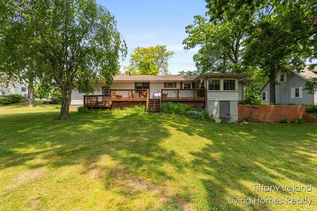 11737 W Carson City Rd, Greenville, MI 48838 - view of green lawn with a wooden deck