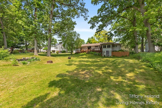 11737 W Carson City Rd, Greenville, MI 48838 - view of grassy yard featuring a wooden deck and stairway