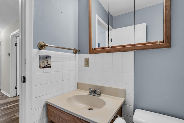 11786 E Sauk Trl, Jerome, MI 49249 - bathroom featuring tile walls, vanity, and wood finished floors