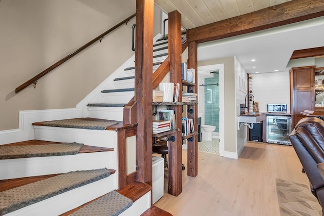 11786 E Sauk Trl, Jerome, MI 49249 - staircase featuring wine cooler, wood finished floors, bar area, recessed lighting, and beamed ceiling