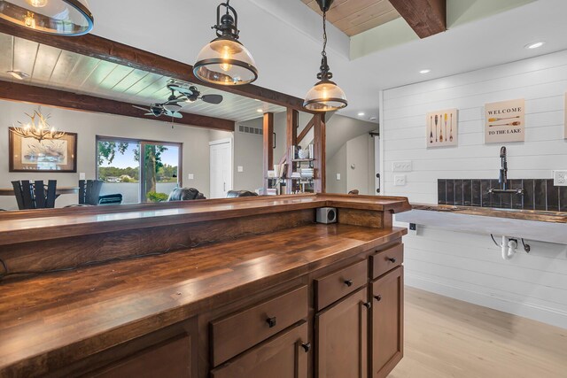 11786 E Sauk Trl, Jerome, MI 49249 - kitchen featuring butcher block counters, light wood-style flooring, a wooden ceiling with exposed beams, pendant lighting, and open floor plan