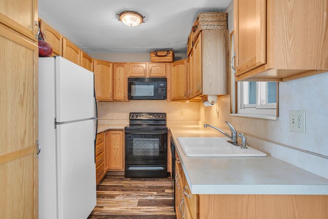 11786 E Sauk Trl, Jerome, MI 49249 - kitchen with black appliances, light countertops, dark wood finished floors, and light brown cabinets