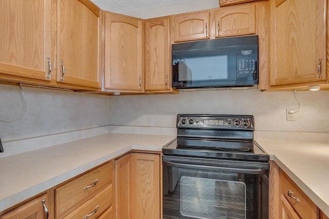11786 E Sauk Trl, Jerome, MI 49249 - kitchen featuring black appliances, light brown cabinets, and light countertops