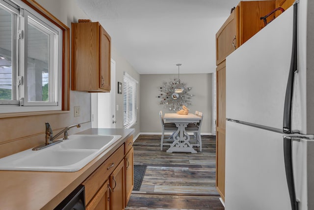 11786 E Sauk Trl, Jerome, MI 49249 - kitchen featuring freestanding refrigerator, dark wood-style floors, healthy amount of natural light, and decorative light fixtures