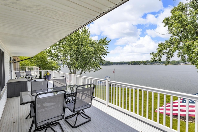 11786 E Sauk Trl, Jerome, MI 49249 - wooden terrace with a water view, outdoor dining space, and a lawn