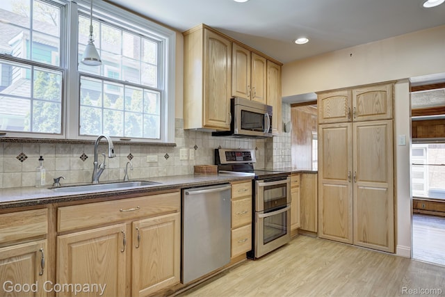 20 Oxford Blvd, Pleasant Ridge, MI 48069 - kitchen featuring appliances with stainless steel finishes, light brown cabinets, tasteful backsplash, plenty of natural light, and recessed lighting