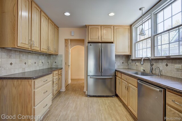 20 Oxford Blvd, Pleasant Ridge, MI 48069 - kitchen with stainless steel appliances, light brown cabinets, light wood-type flooring, dark countertops, and tasteful backsplash