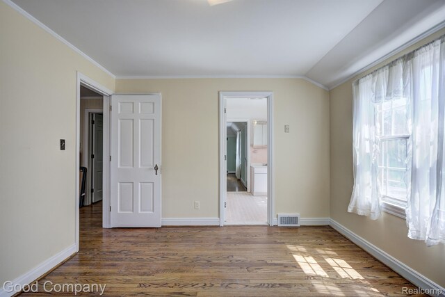 20 Oxford Blvd, Pleasant Ridge, MI 48069 - unfurnished bedroom with multiple windows, ornamental molding, wood finished floors, vaulted ceiling, and ensuite bathroom