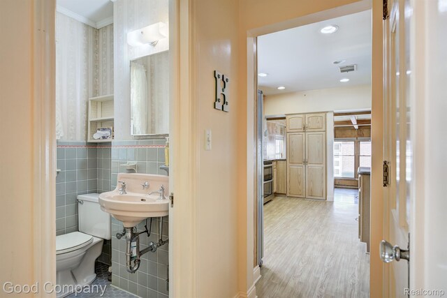 20 Oxford Blvd, Pleasant Ridge, MI 48069 - half bathroom featuring ornamental molding, wallpapered walls, wood finished floors, and recessed lighting