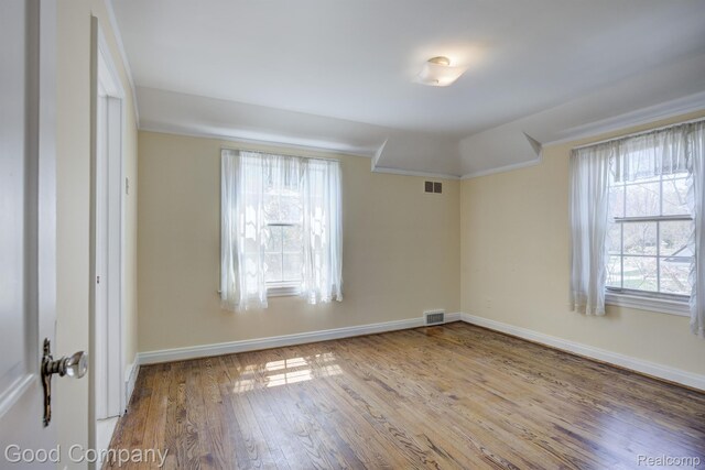 20 Oxford Blvd, Pleasant Ridge, MI 48069 - empty room with healthy amount of natural light, wood finished floors, and crown molding