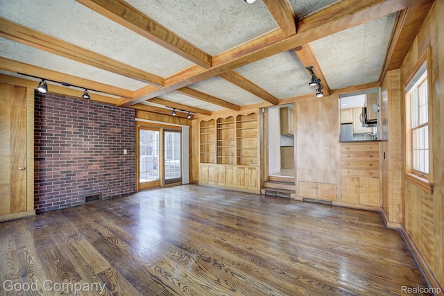 20 Oxford Blvd, Pleasant Ridge, MI 48069 - unfurnished living room with track lighting, dark wood-style floors, beam ceiling, plenty of natural light, and wooden walls