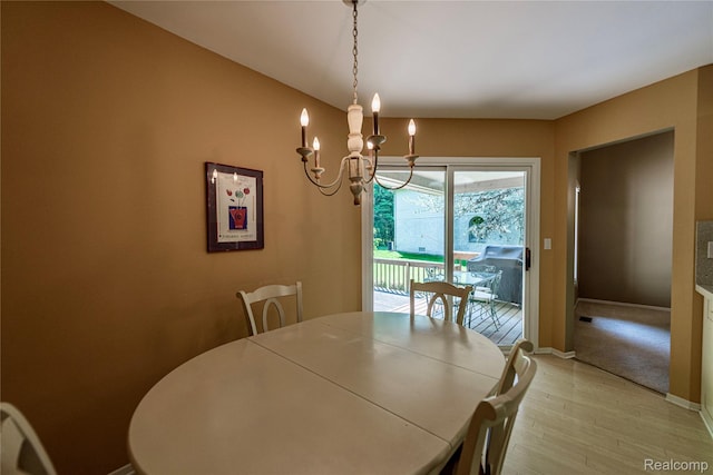 6760 Oyster Cv, West Bloomfield, MI 48323 - dining area with light wood-style floors and a chandelier