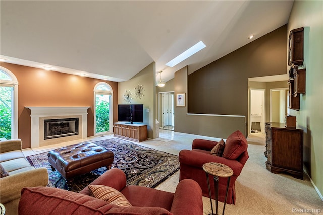6760 Oyster Cv, West Bloomfield, MI 48323 - living room with high vaulted ceiling, a skylight, light colored carpet, and a glass covered fireplace