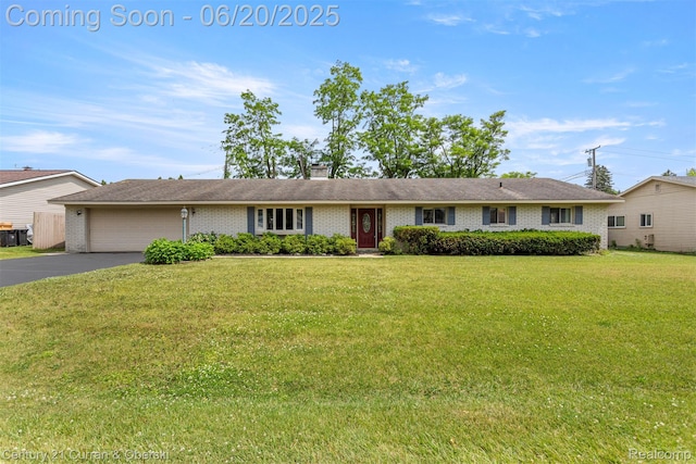 2138 Metzner Rd, Commerce Twp, MI 48390 - ranch-style house with a garage, driveway, a front lawn, and a chimney