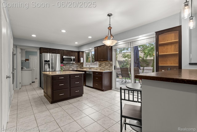 2138 Metzner Rd, Commerce Twp, MI 48390 - kitchen with appliances with stainless steel finishes, dark brown cabinetry, tasteful backsplash, light tile patterned floors, and recessed lighting