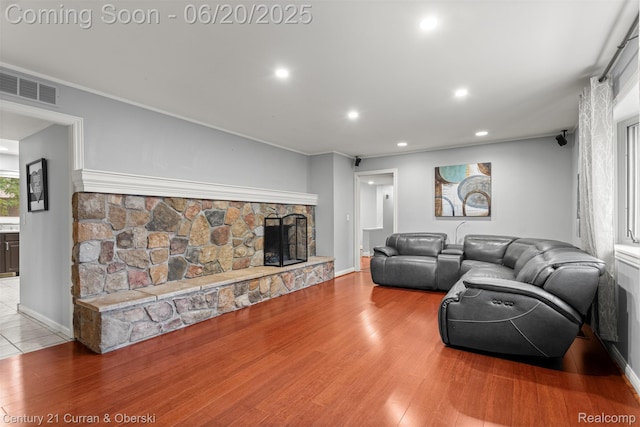 2138 Metzner Rd, Commerce Twp, MI 48390 - living area with light wood finished floors, a stone fireplace, recessed lighting, and crown molding