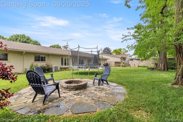 2138 Metzner Rd, Commerce Twp, MI 48390 - view of yard with a fire pit, a trampoline, and a patio area