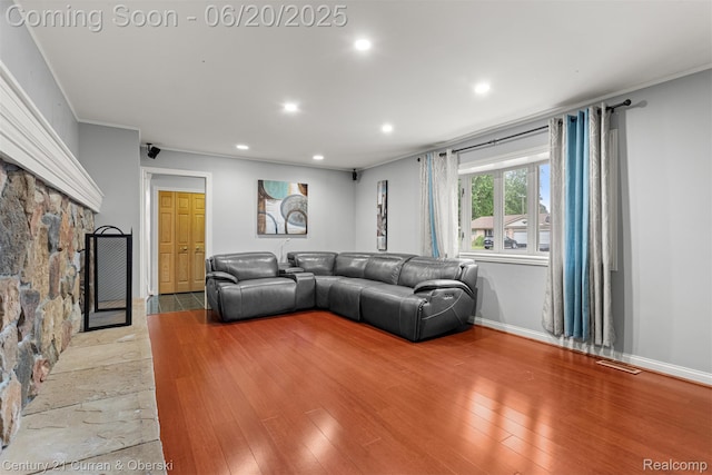 2138 Metzner Rd, Commerce Twp, MI 48390 - living area featuring recessed lighting, light wood-style floors, a fireplace, and crown molding