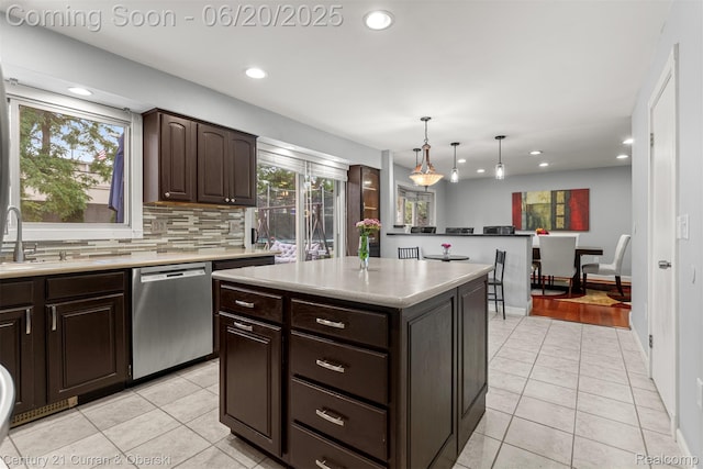 2138 Metzner Rd, Commerce Twp, MI 48390 - kitchen with dishwasher, light tile patterned floors, recessed lighting, dark brown cabinets, and decorative backsplash