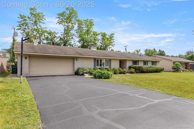 2138 Metzner Rd, Commerce Twp, MI 48390 - single story home featuring a garage, asphalt driveway, brick siding, a front yard, and a chimney