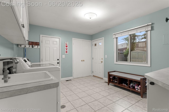 2138 Metzner Rd, Commerce Twp, MI 48390 - laundry room featuring cabinet space, washing machine and clothes dryer, and light tile patterned floors