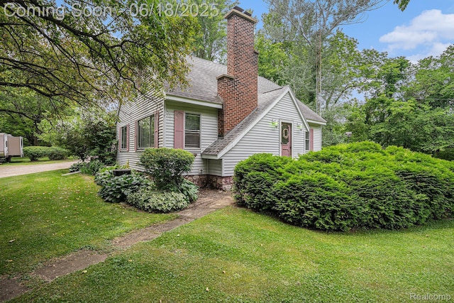 44988 52nd St, Lawrence, MI 49064 - view of side of property with roof with shingles, a chimney, and a lawn