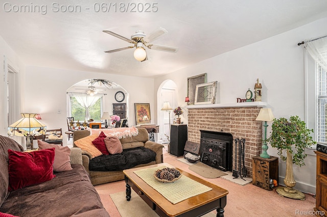 44988 52nd St, Lawrence, MI 49064 - living room featuring arched walkways, a ceiling fan, a brick fireplace, and light carpet