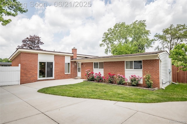 8311 Gulley St, Taylor, MI 48180 - view of front of home with brick siding, a chimney, and a patio area