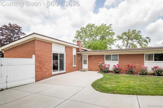 8311 Gulley St, Taylor, MI 48180 - view of front of property featuring brick siding, a chimney, and a patio