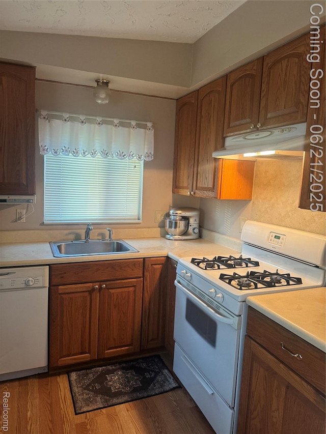 8311 Gulley St, Taylor, MI 48180 - kitchen with white appliances, under cabinet range hood, and light countertops