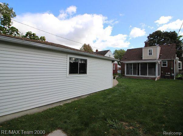 22902 Olmstead St, Dearborn, MI 48124 - view of grassy yard with a sunroom