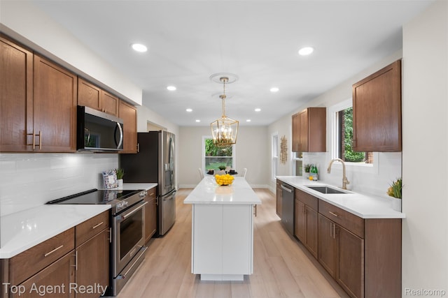14638 Greenview Rd, Detroit, MI 48223 - kitchen with stainless steel appliances, a center island, light wood-style floors, backsplash, and recessed lighting
