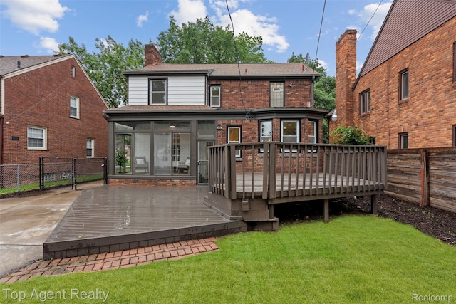 14638 Greenview Rd, Detroit, MI 48223 - back of house featuring a sunroom, a fenced backyard, a chimney, a wooden deck, and brick siding