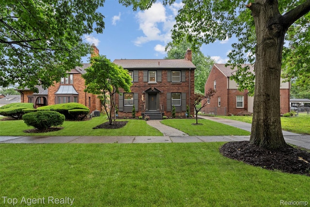 14638 Greenview Rd, Detroit, MI 48223 - view of front of house featuring a chimney, a front yard, and brick siding