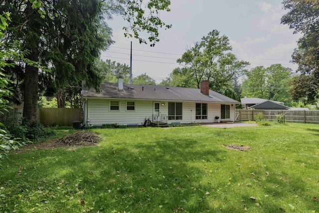 531 Gettysburg Dr, Niles, MI 49120 - rear view of house featuring a fenced backyard, a patio area, and a chimney
