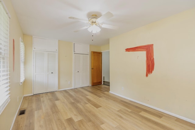 531 Gettysburg Dr, Niles, MI 49120 - unfurnished bedroom featuring light wood-style flooring, multiple closets, and ceiling fan