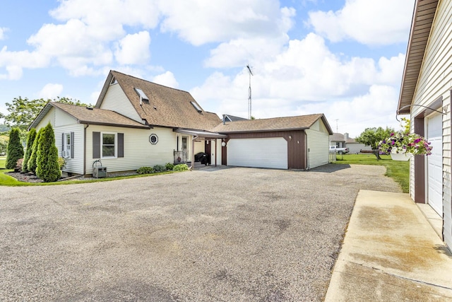 8856 Kingsley Dr, Onsted, MI 49265 - view of front of house with roof with shingles, an outdoor structure, and a garage