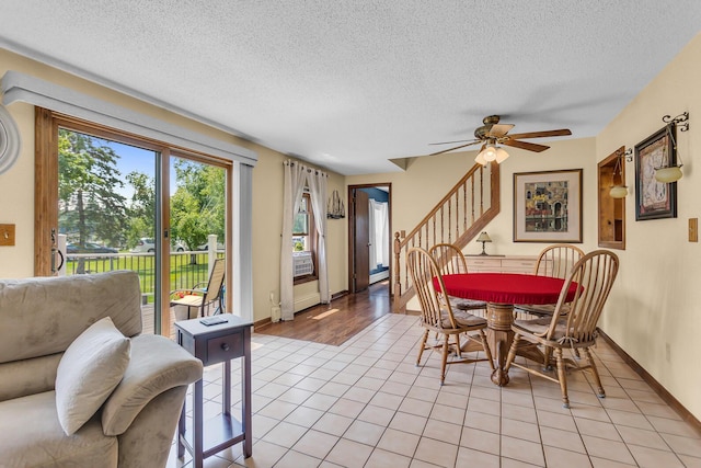 8856 Kingsley Dr, Onsted, MI 49265 - dining room with a ceiling fan, a textured ceiling, stairway, and light tile patterned flooring
