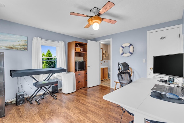 8856 Kingsley Dr, Onsted, MI 49265 - home office with a ceiling fan and wood finished floors
