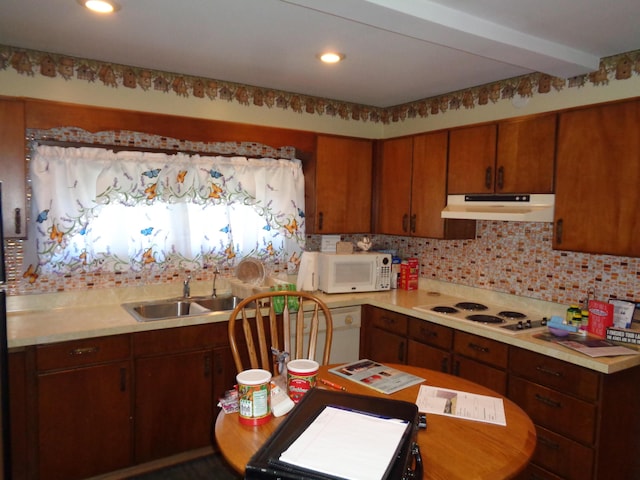 205 Prentiss St, Allen, MI 49227 - kitchen with white appliances, under cabinet range hood, light countertops, decorative backsplash, and recessed lighting