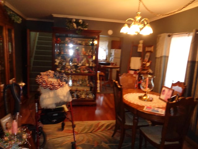 205 Prentiss St, Allen, MI 49227 - dining area with ornamental molding, wood finished floors, stairway, and a chandelier