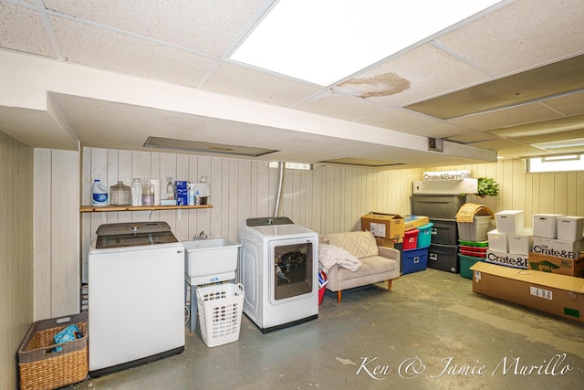 6072 Del Cano Dr SE, Grand Rapids, MI 49546 - below grade area with wooden walls, a drop ceiling, and separate washer and dryer