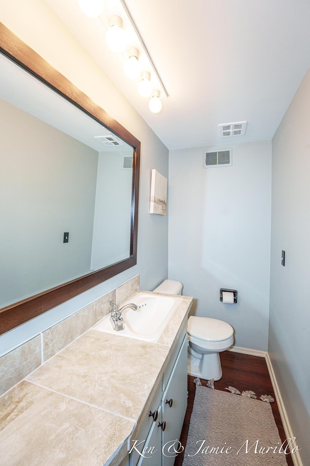6072 Del Cano Dr SE, Grand Rapids, MI 49546 - half bathroom featuring vanity and wood finished floors