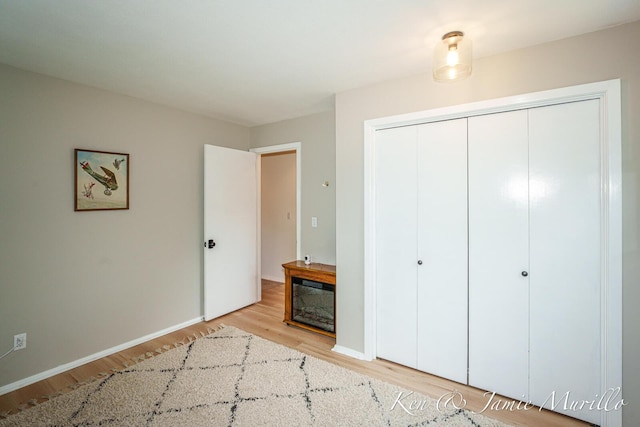 6072 Del Cano Dr SE, Grand Rapids, MI 49546 - unfurnished bedroom with wood finished floors and a closet