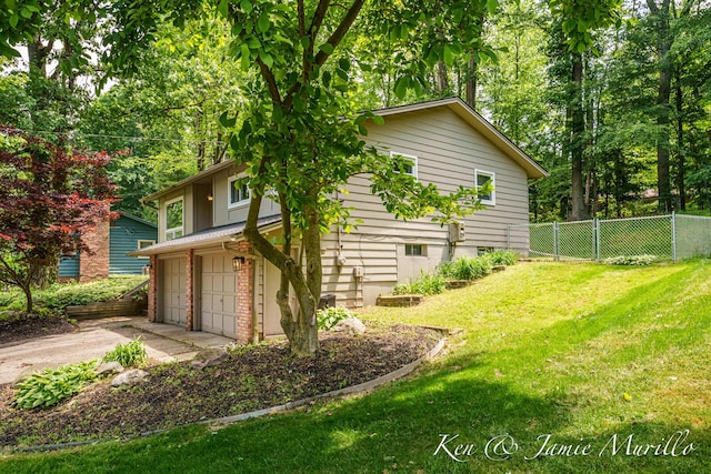 6072 Del Cano Dr SE, Grand Rapids, MI 49546 - view of property exterior featuring driveway and a garage