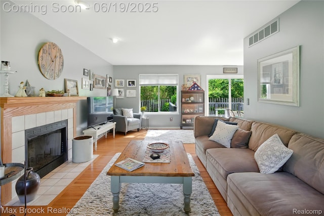7950 Sandmar Ln, Davisburg, MI 48350 - living room featuring light wood-style floors and a tile fireplace