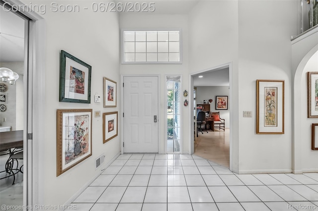 7569 Danbury Cir W, Bloomfield, MI 48322 - entryway featuring a high ceiling, light tile patterned flooring, and a chandelier