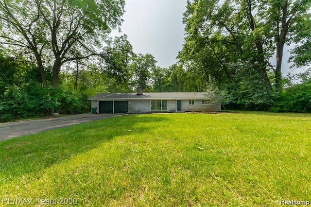 28045 W Greenmeadow Cir, Farmington Hills, MI 48334 - ranch-style home with asphalt driveway, an attached garage, and a front lawn