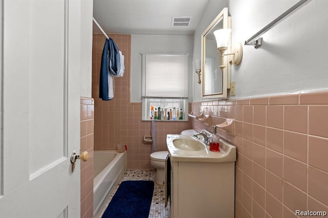 17041 Henry St, Melvindale, MI 48122 - full bath featuring tile walls, vanity, a wainscoted wall, and tile patterned flooring